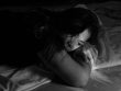 woman leaning on bed