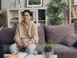 a woman sitting on a couch talking to another woman