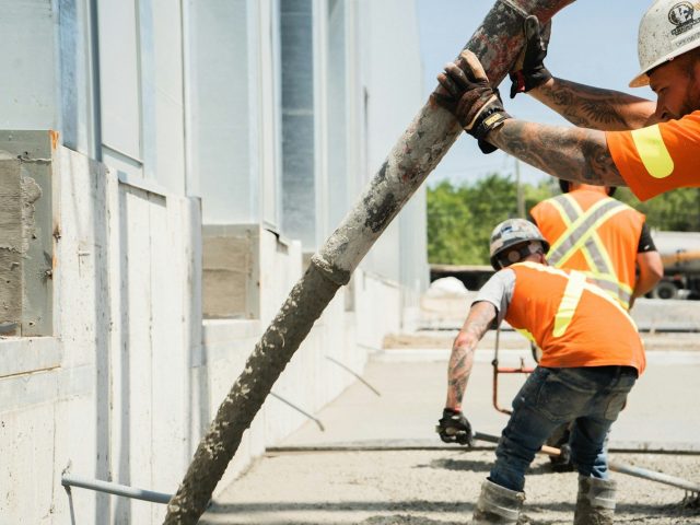 a group of construction workers working on a building